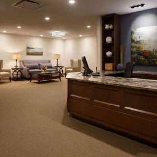 A spacious reception area with comfortable seating and soft lighting.