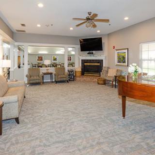 A spacious living room featuring a fireplace, television, and comfortable seating.