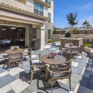 A sunny outdoor patio area with tables and chairs, perfect for gatherings.