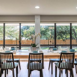 A modern seating area with natural light streaming through large windows.