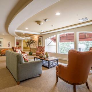A cozy living room with comfortable seating and large windows.