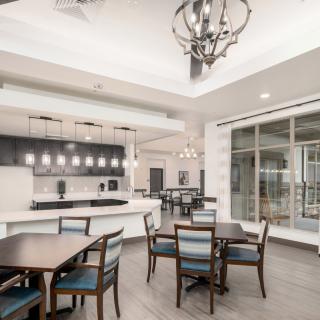 A modern dining area with stylish furniture and contemporary lighting fixtures.