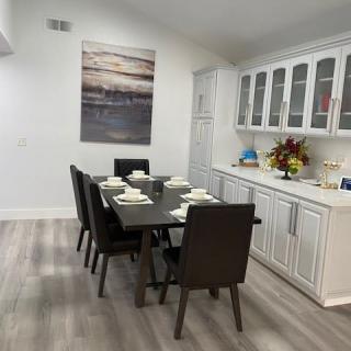 A modern dining room with a set table and elegant decorations.