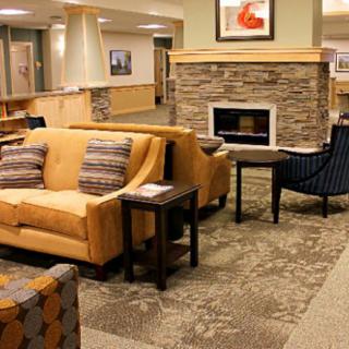 A modern lobby with comfortable seating and a cozy fireplace.