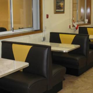 An empty diner with classic booth seating and a retro interior design.