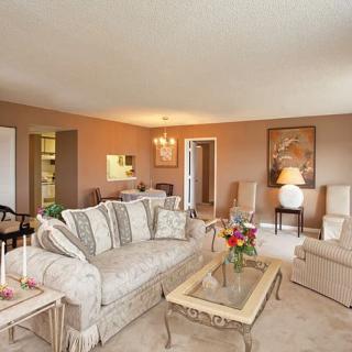 A well-decorated living room featuring a comfortable sofa, elegant furniture, and tasteful decor.