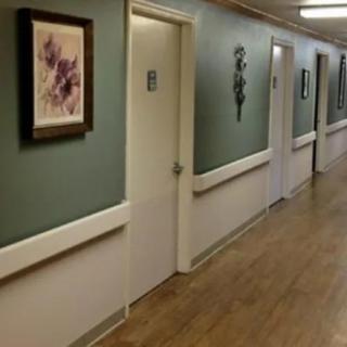 A corridor with multiple doors and a painting on the wall.