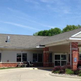 A one-story building with a brick facade and a covered entrance.