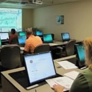 Students attending a computer-based training session in a classroom.