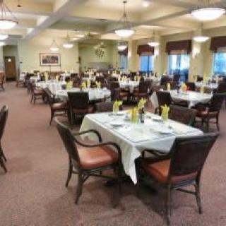 Elegant dining room with tables set for guests.