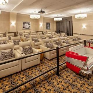 A cozy and luxurious small theater with plush seating designed for an intimate home cinema experience.