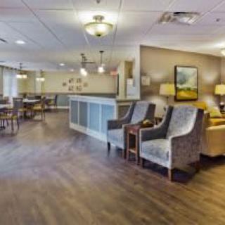 A well-lit lobby area with comfortable seating and a reception desk.
