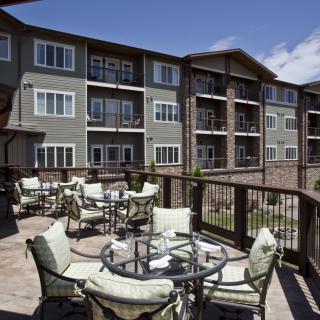 A modern apartment building with a spacious outdoor seating area.