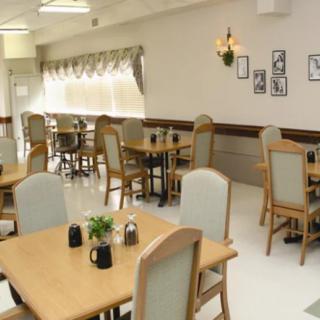 A cozy, well-lit restaurant dining area with neatly arranged tables and chairs.