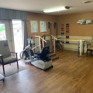 A well-equipped rehabilitation therapy room with exercise equipment and a welcoming atmosphere.