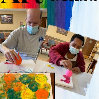 Participants enjoying a creative art class, pouring colorful paint onto canvases.