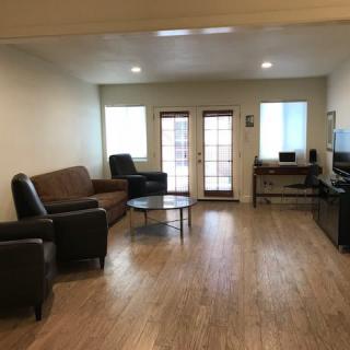 Minimalist living room with hardwood floors and comfortable seating.