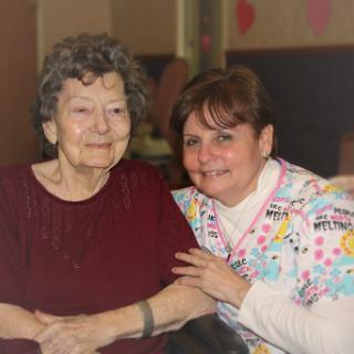 A warm moment shared between a caregiver and an elderly resident.
