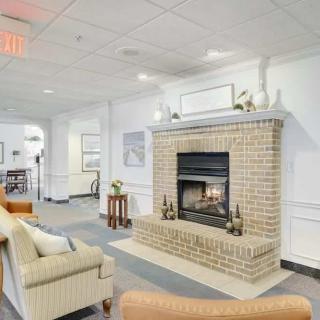 A cozy living room with a brick fireplace and comfortable seating.