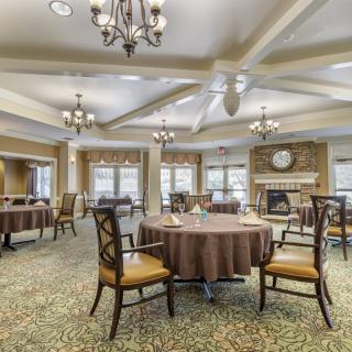 Elegant dining area with round tables and chandeliers.