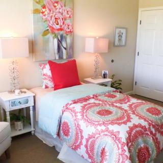 A beautifully decorated bedroom with colorful bedding and matching decor accents.