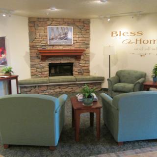 A cozy living room with a fireplace and seating area.
