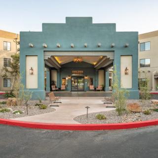 A modern building entrance with distinctive architectural features and landscaped surroundings.