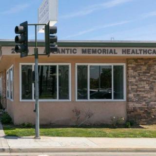 Exterior view of a healthcare clinic building on a sunny day.