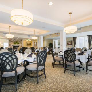 An elegant dining room with stylish seating and decorative chandeliers.