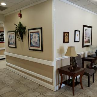 A cozy waiting area featuring wall art and comfortable seating.