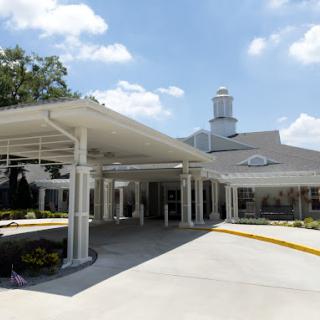A welcoming entrance to a residential facility under a clear blue sky.