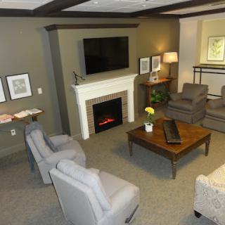 A cozy and modern living room featuring comfortable seating, a fireplace, and a television.