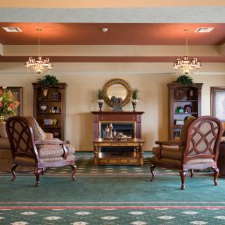 An elegant living room with classic furniture and a fireplace.