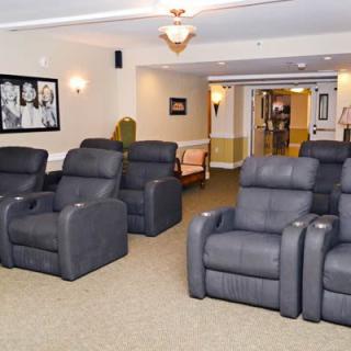 A modern lounge area featuring multiple recliner chairs arranged in rows.