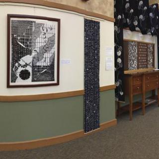 A gallery showcasing a black and white artwork along with other decorative elements.