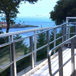 A scenic view of a waterfront with an accessible wheelchair ramp in the foreground.