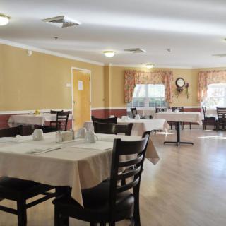 An empty restaurant dining area with neatly set tables and chairs.
