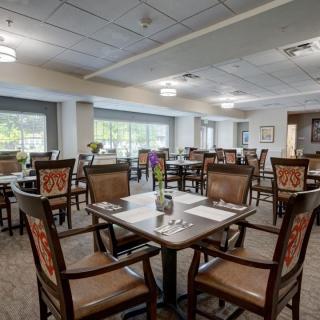 Spacious and well-lit dining area with neatly arranged tables and chairs.