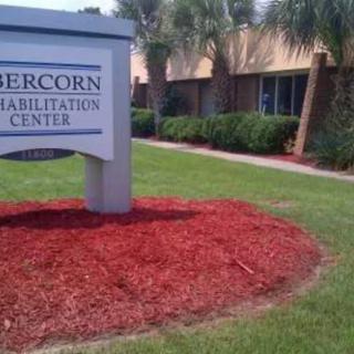 A sign for the Abercorn Rehabilitation Center in front of a well-maintained building with landscaping.