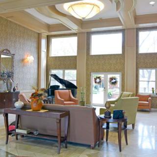A luxurious living room featuring elegant furniture and a grand piano.