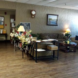 A cozy waiting area with floral decorations and comfortable seating.