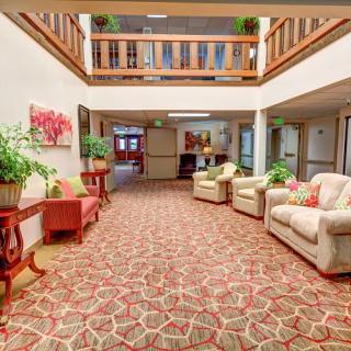 A cozy lobby area with comfortable seating and decorative plants.