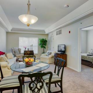 A cozy living and dining area with modern furnishings and neutral tones.