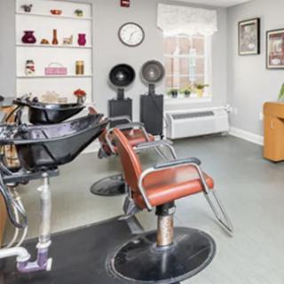 A modern hair salon featuring styling chairs and equipment, designed for comfortable hair treatments.