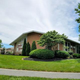 A building surrounded by well-maintained landscaping with trees and shrubs.