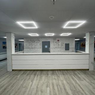 A modern reception area featuring minimalist design and contemporary lighting.