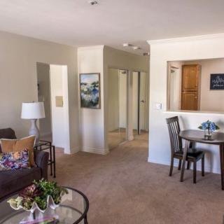 A cozy living room with a dining area, featuring comfortable furniture and tasteful decor.