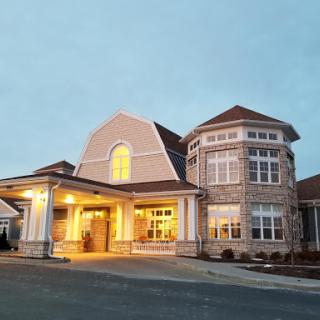 A beautifully designed residential building illuminated at dusk.