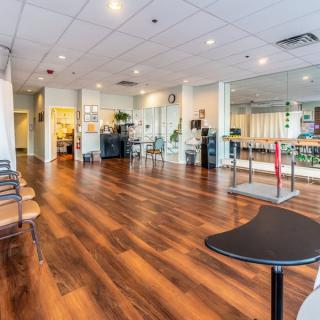 A spacious exercise room with fitness equipment and a mirrored wall.