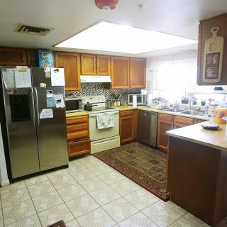 A cozy kitchen with wooden cabinets and modern appliances.